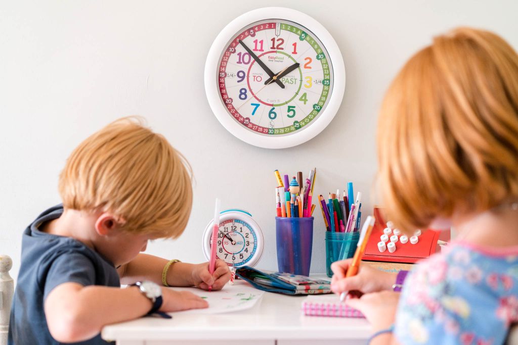 Two Children learning how to tell the time with an EasyRead Time Teacher Wall Clock